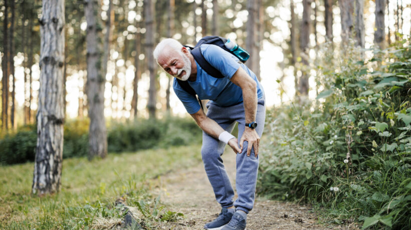 Older man pauses on a walk due to leg pain from peripheral artery disease